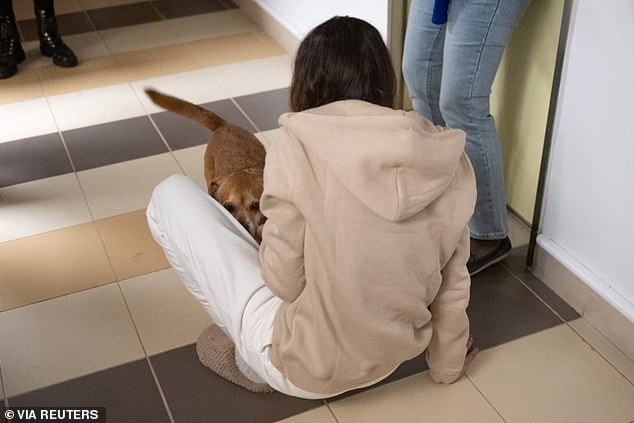 Moran Stela Yanai, 40, greets the family dog following her arrival in Israel, at Sheba Medical Center in Ramat Gan, Israel, in this handout image obtained by Reuters on November 30, 2023