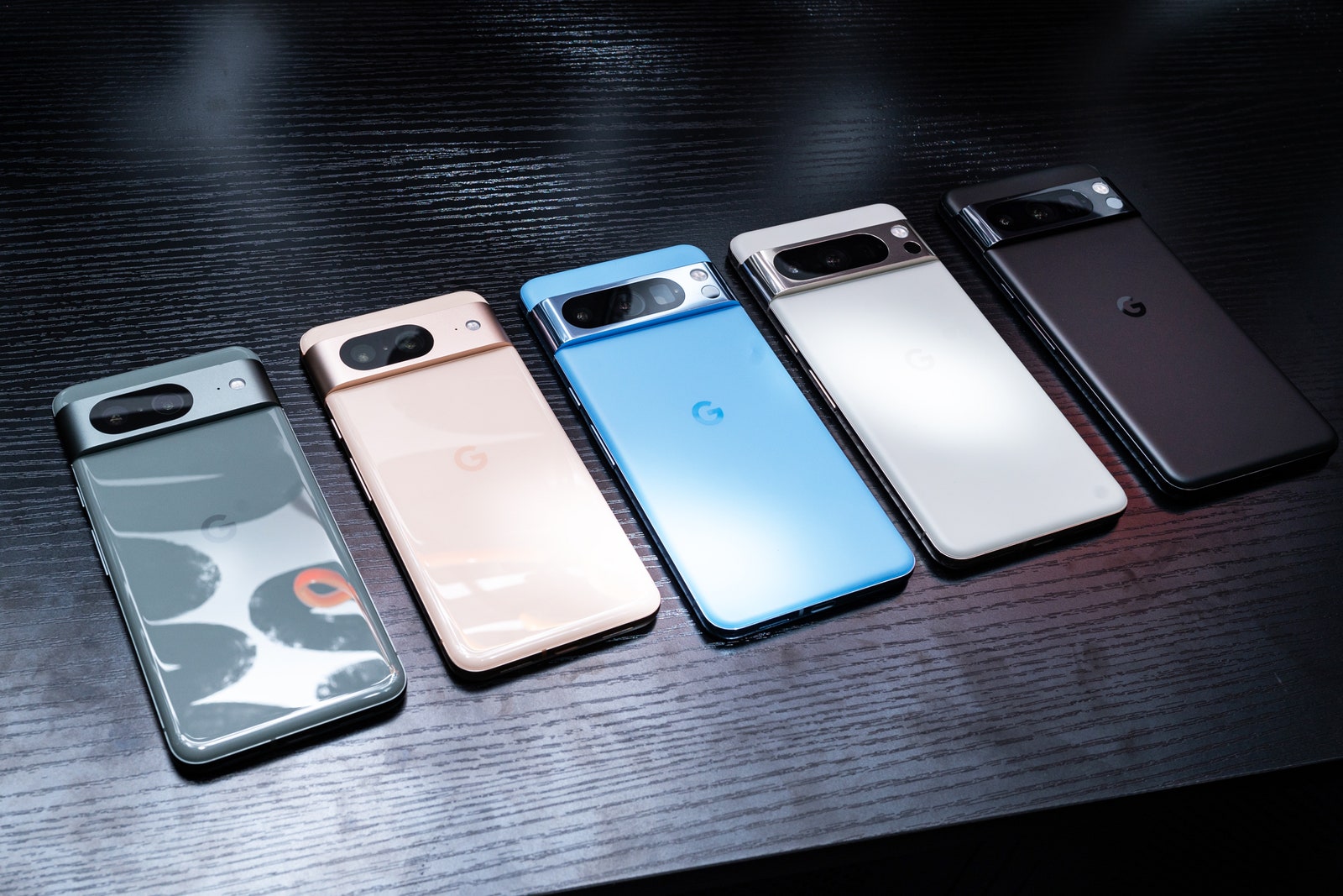 Google Pixel 8 smartphones in various colors on a table
