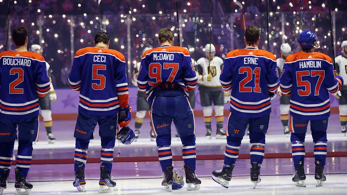 Oilers players wait