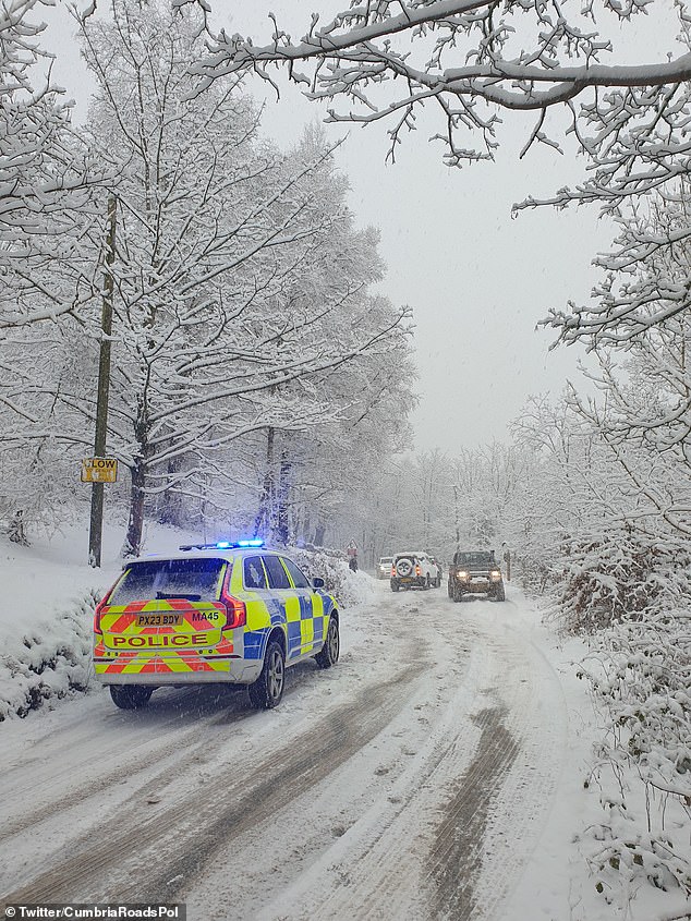 Cumbria Police urged people not to travel to the county today after it declared a major incident because of heavy snowfall on the county's roads. Pictured: Cars caught up in the heavy snowfall in Cumbria on Saturday
