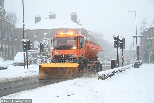A snow plough drives across the road in the Peak District after heavy snow fell overnight into Sunday morning