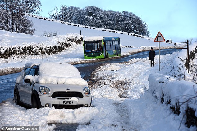 An abandoned car and bus on the A591 between Kendal and Windermere after yesterday's heavy snow falls
