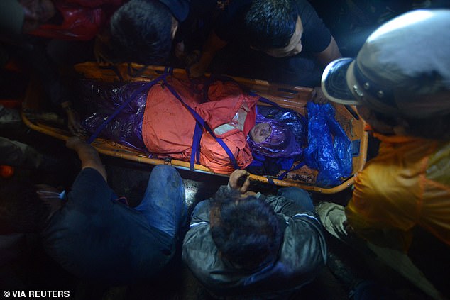 Rescue teams evacuate a victim of the eruption of Mount Marapi. Three people found by rescuers were alive