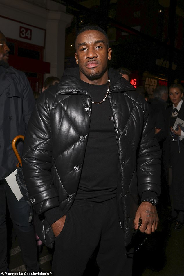 Bugzy Malone looked trendy in a black T-shirt and trousers, styled with a black padded jacket