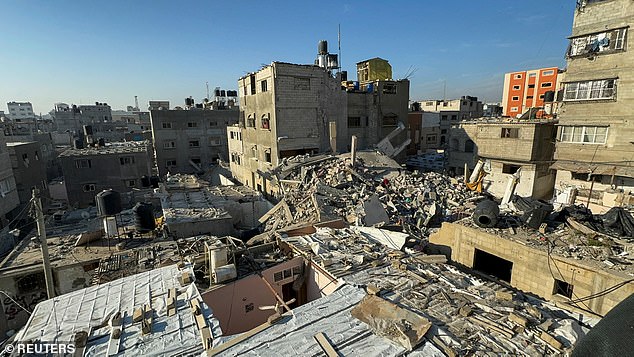Rubble of destroyed buildings lies at the site of Israeli strike in n Khan Younis in the southern Gaza Strip on Friday
