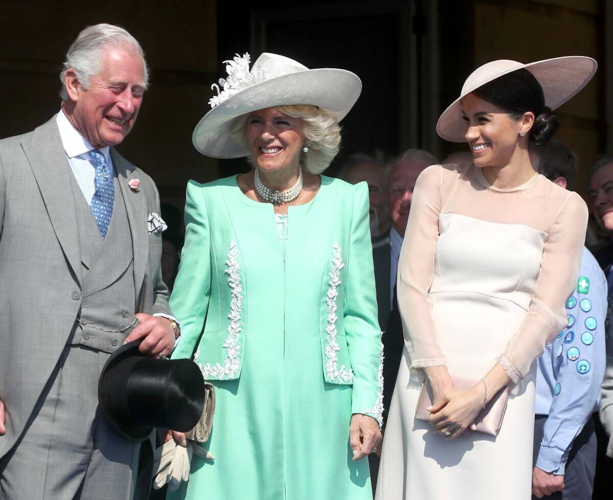 King Charles, Camilla Parker Bowles (now Queen Camilla), and Meghan Markle share a laugh during Charles' 70th Birthday Patronage Celebration